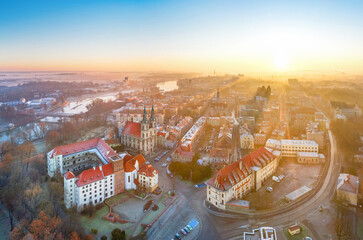 Brzeg, Poland. Aerial cityscape on sunrise with Piast castle and Church of the Holy Cross