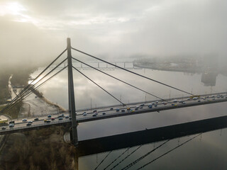 Obraz premium Aerial drone view. North bridge in Kiev, shrouded in morning fog.