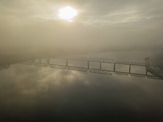 Aerial drone view. Railway bridge in Kiev, shrouded in morning fog.