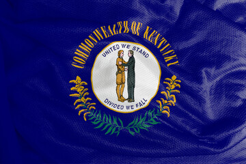The Kentucky flag is a flag with the seal of Kentucky on a navy blue field, surrounded by the words Commonwealth or Kentucky at the top and golden twigs at the bottom. 