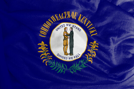 The Kentucky flag is a flag with the seal of Kentucky on a navy blue field, surrounded by the words Commonwealth or Kentucky at the top and golden twigs at the bottom. 
