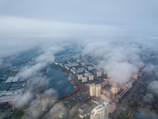 Aerial drone view. Low clouds over the Dnieper river in Kiev. Foggy autumn morning.
