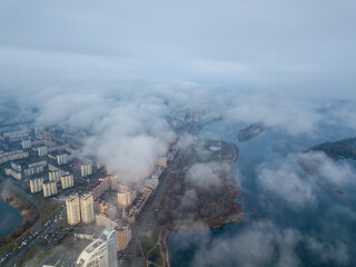 Aerial drone view. Low clouds over the Dnieper river in Kiev. Foggy autumn morning.