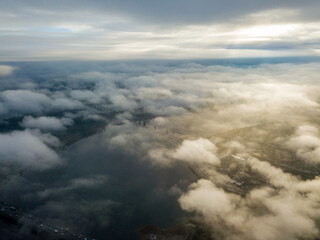 Fototapeta na wymiar Aerial drone view. Low clouds over the Dnieper river in Kiev. Foggy autumn morning.