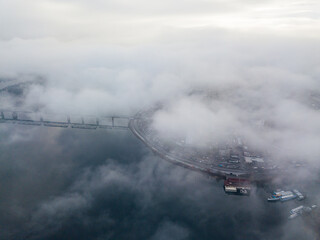 Fototapeta premium Aerial drone view. Low clouds over the Dnieper river in Kiev. Foggy autumn morning.