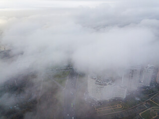 Aerial drone view. Low clouds over the Dnieper river in Kiev. Foggy autumn morning.