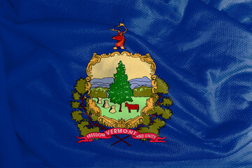 The Vermont flag is the state’s coat of arms on a blue field. Below this coat of arms is a red...