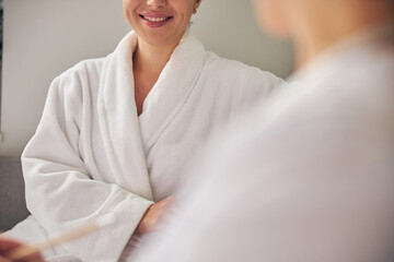 Fototapeta premium Happy spa client sitting next to a cosmetologist