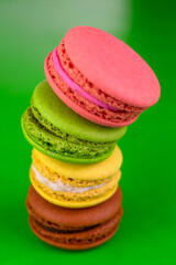 
Macarons on a bright green background.
French colorful macaroons.
Close-up.