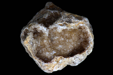 Crystalline calcite geode (CaCO3) in limestone on black background
