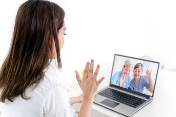 Happy woman doing video call with her parents