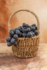 Fototapeta na wymiar front view fresh black grapes inside basket on a light background fruit wine color photo