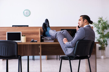 Young male employee working in the office