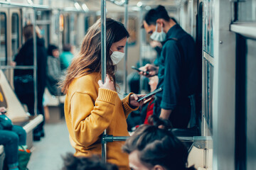 variety of passengers ride the subway car