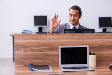 Young male employee working in the office