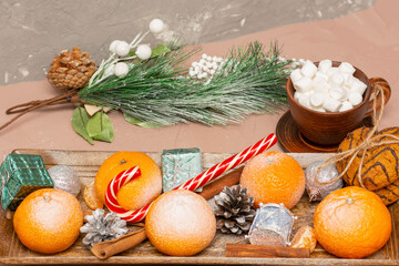 Tangerines and coffee with marshmallows in New Year's composition. Christmas table, close-up, selective focus
