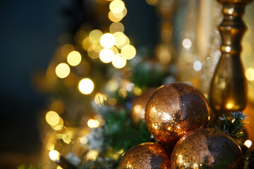 Bright New Year's Christmas lights, balls and toys hang on the tree and shimmer in different colors