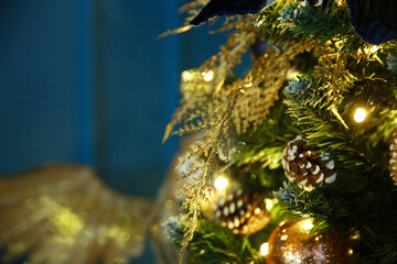 Bright New Year's Christmas lights, balls and toys hang on the tree and shimmer in different colors