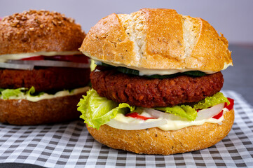 Tasty hamburger made with vegetarian plant based imitation minced meat burger and fresh vegetables