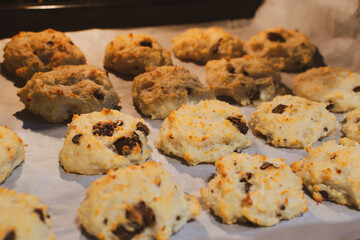 Homemade oatmeal ruddy cookies with raisin on the baking sheet close-up
