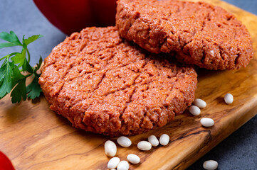 Tasty uncooked burger made with vegetarian plant based imitation minced meat ready for grill