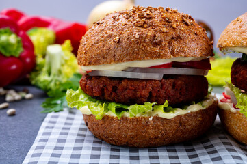 Tasty hamburger made with vegetarian plant based imitation minced meat burger and fresh vegetables
