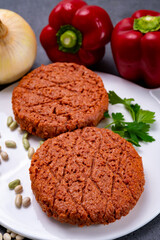 Tasty uncooked burger made with vegetarian plant based imitation minced meat ready for grill