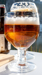 Drinking of dark and strong Belgian abbey beer with cheeses with nice view on Maas river and town Dinant, Belgium