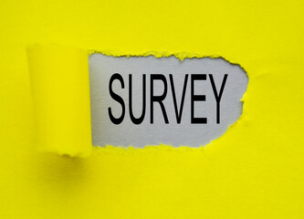 Business concept for research on the method used for data collection, the word survey is written on a gray background wrapped in a yellow paper tear