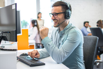 Technical support operator working with headset in call center office
