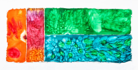 abstract colorful hand-coloured fabric in batik technique with salt spots ion white background
