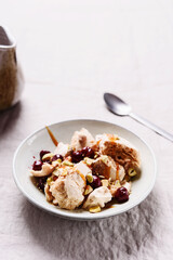 Not traditional Eton mess. Meringue, pistachio, cherry and caramel sauce dessert. Selective focus