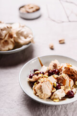 Not traditional Eton mess. Meringue, pistachio, cherry and caramel sauce dessert. Selective focus