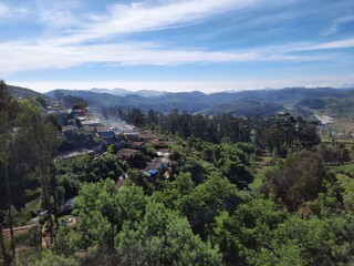 Obraz premium beautiful view of hill mountain green forest with blue sky mist rain clouds background