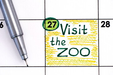 Reminder Visit the ZOO in calendar with pen.