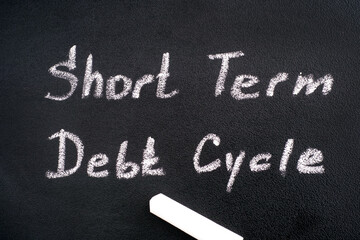 Blackboard with words Short Term Debt Cycle and chalk.