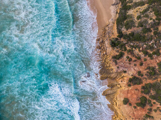 Fototapeta na wymiar Top down aerial drone shot of waves crashing on beach (Algarve/Portugal)