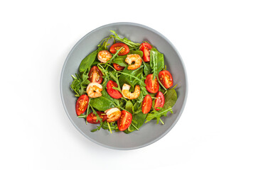 Salad of shrimp prawn and fresh vegetable, leaves of arugula, lettuce.
