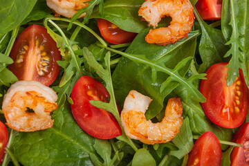 Salad of shrimp prawn and fresh vegetable, leaves of arugula, lettuce.