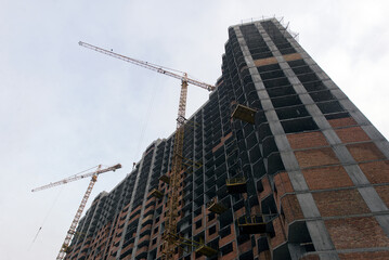 Tower crane. Construction site. Production of apartments, social housing.