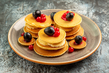 Close up view of fruit pancakes on gray background