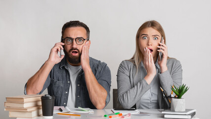 Frightened and shocked man with beard and glasses and with open mouths in workplace