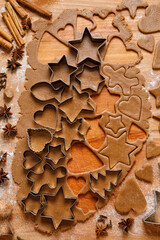 Cutting different shapes of Christmas gingerbread cookies from the dough, top view