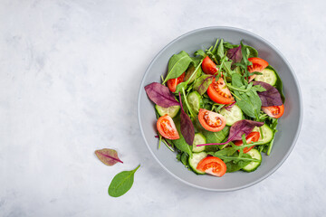 Healthy fresh salad of vegetable cucumber, tomato, spinach, arugula