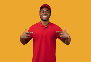 Smiling black delivery man pointing at himself