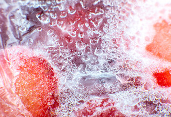 Frozen strawberries texture. Close up. Cold fruit in snow. Ice in the fridge. Frost background.