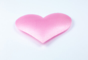 Fototapeta premium Pink heart on white background. Saint Valentine's day concept. Love and romantic photo. Postcard for holiday. Beautiful warm wallpaper with love. Soft focus. Copy space.