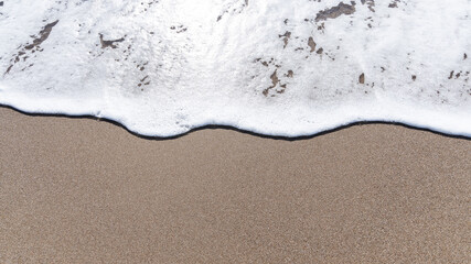 Sparkling waves hitting the shore on the beach on sunny day at Summer, sand beige background image, Holiday, Travel Concept in Antalya Turkey.