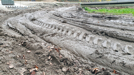 Muddy road at the construction site. Turn.