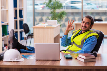 Young male architect working in the office